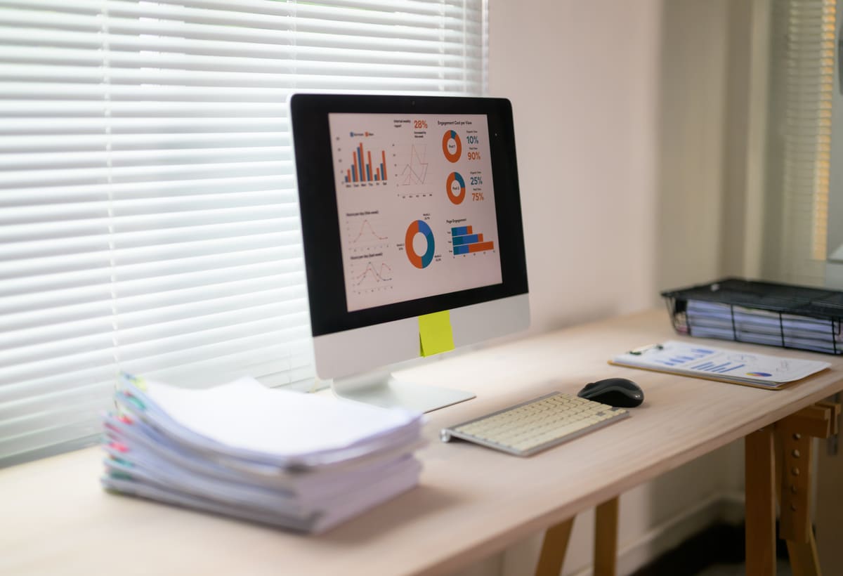 Business graphs and records reviewed on a desk