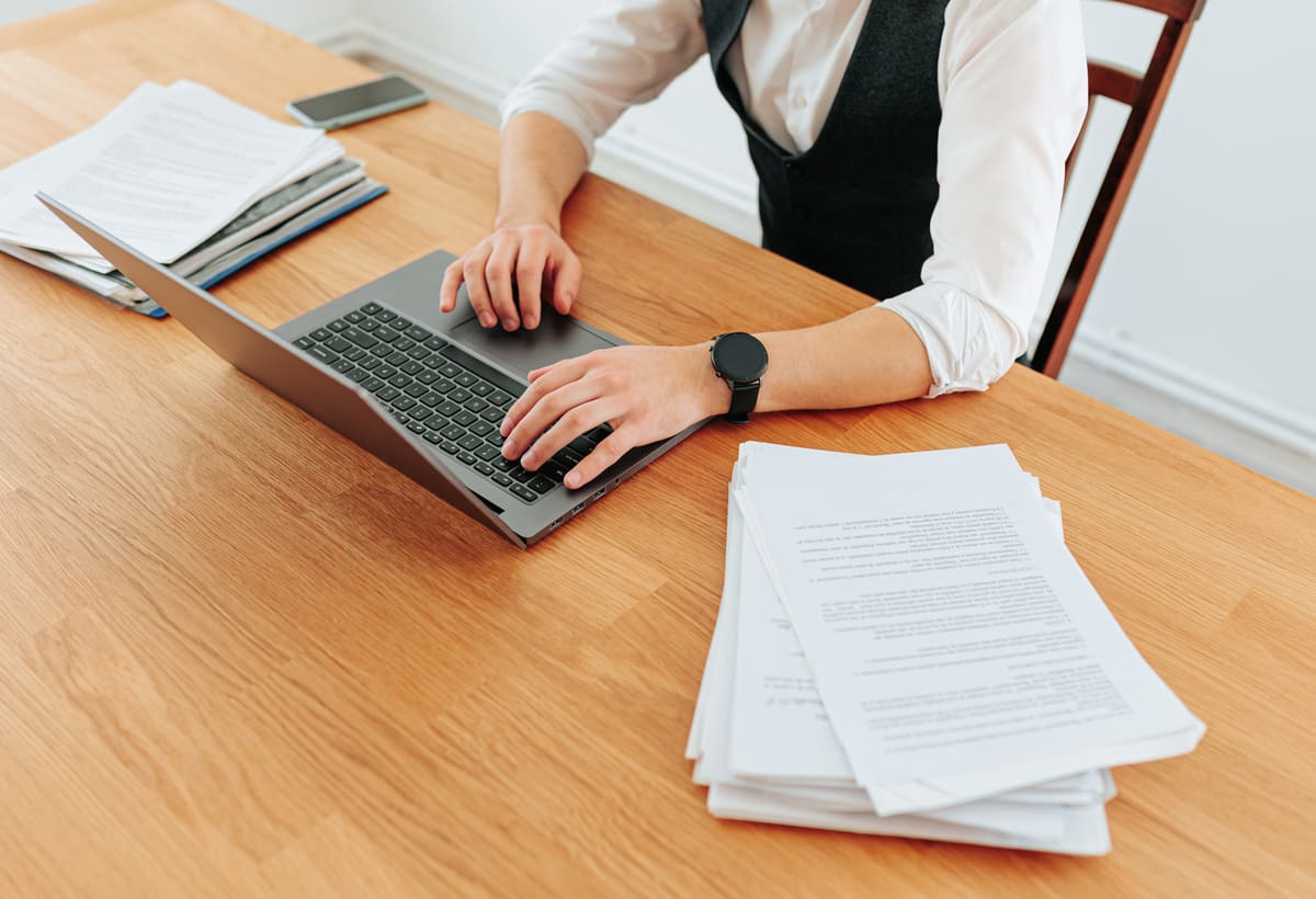 Hands typing on a laptop during confidential due diligence review